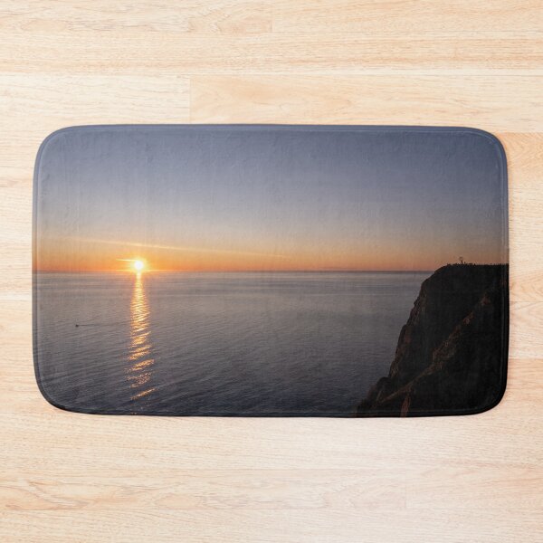 Item preview, Wonderful landscapes in Norway. Nord-Norge. Beautiful scenery of a midnight sun sunset at Nordkapp (Cape North). Boat and globe on a cliff. Rippled sea and clear orange sky.  designed and sold by Maurizio Fabbroni.