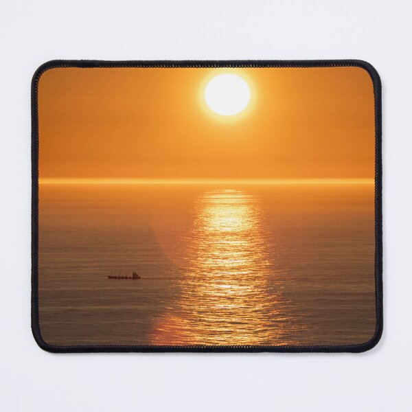 Item preview, Wonderful landscapes in Norway. Nord-Norge. Beautiful scenery of a midnight sun sunset at Nordkapp (Cape North). Boat and globe on a cliff. Rippled sea and clear orange sky.  designed and sold by Maurizio Fabbroni.
