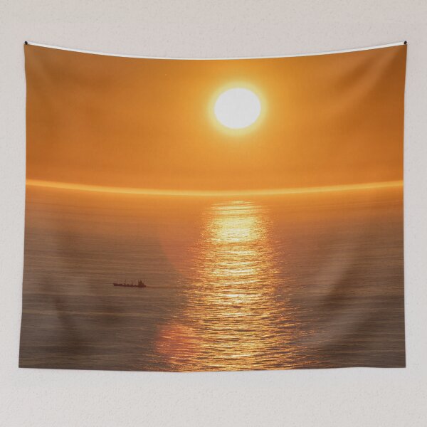 Item preview, Wonderful landscapes in Norway. Nord-Norge. Beautiful scenery of a midnight sun sunset at Nordkapp (Cape North). Boat and globe on a cliff. Rippled sea and clear orange sky.  designed and sold by Maurizio Fabbroni.