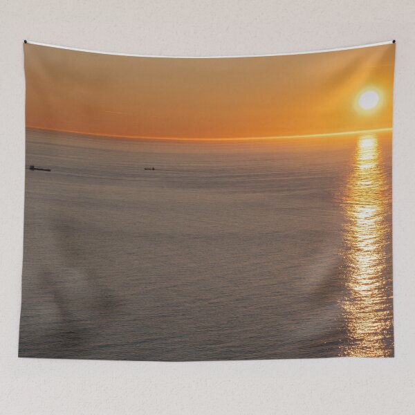 Item preview, Wonderful landscapes in Norway. Nord-Norge. Beautiful scenery of a midnight sun sunset at Nordkapp (Cape North). Boat and globe on a cliff. Rippled sea and clear orange sky.  designed and sold by Maurizio Fabbroni.