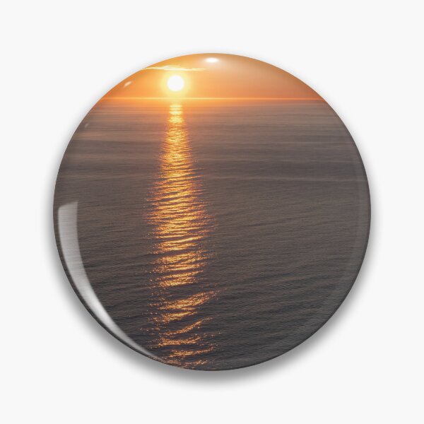 Item preview, Wonderful landscapes in Norway. Nord-Norge. Beautiful scenery of a midnight sun sunset at Nordkapp (Cape North). Boat and globe on a cliff. Rippled sea and clear orange sky. (vertical) designed and sold by Maurizio Fabbroni.