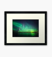Northern lights over lake Framed Print