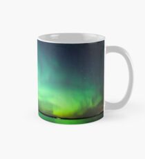 Northern lights over lake Mug
