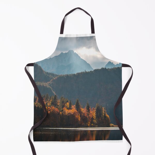 Item preview, Tall mountains over Alpsee lake on a cloudy autumn day - Beautiful orange forest designed and sold by BackpackTravel.