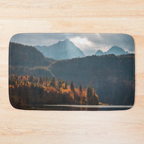 Item preview, Tall mountains over Alpsee lake on a cloudy autumn day - Beautiful orange forest  designed and sold by BackpackTravel.