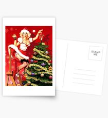 Pin up blond sexy girl is decorating Christmas tree Postcards