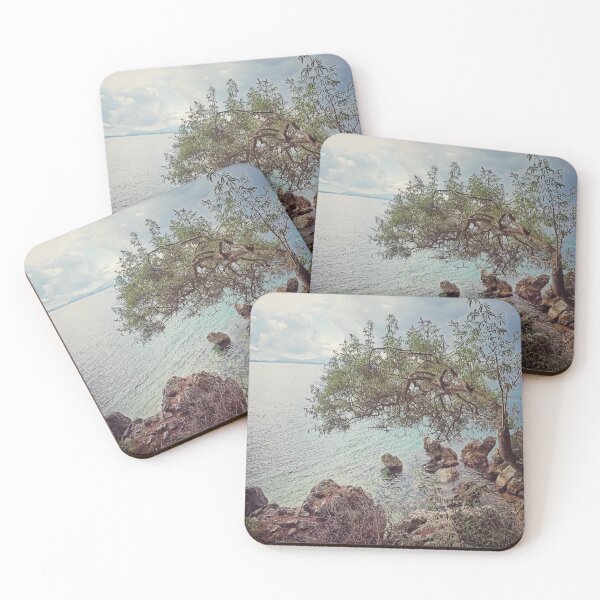 Item preview, SINGLE OLIVE TREE OVERHANGS THE SEA GREECE designed and sold by nickbrayimages.