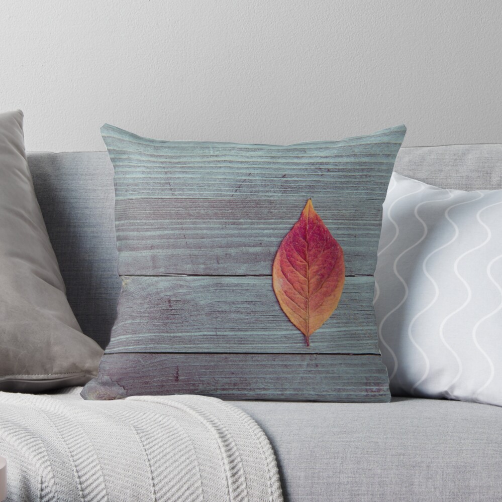 Red autumn leaf on wood Throw Pillow