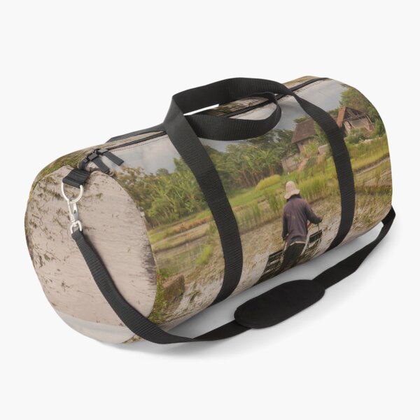 Item preview, A man in backside view plows a village rice field. designed and sold by kall3bu.