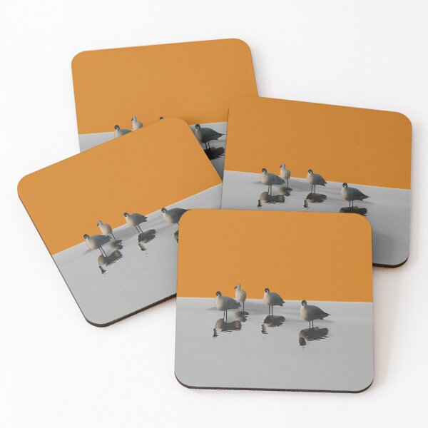 Item preview, Four water birds on a grey beach with orange sunset background. Orange background designed and sold by janesg.