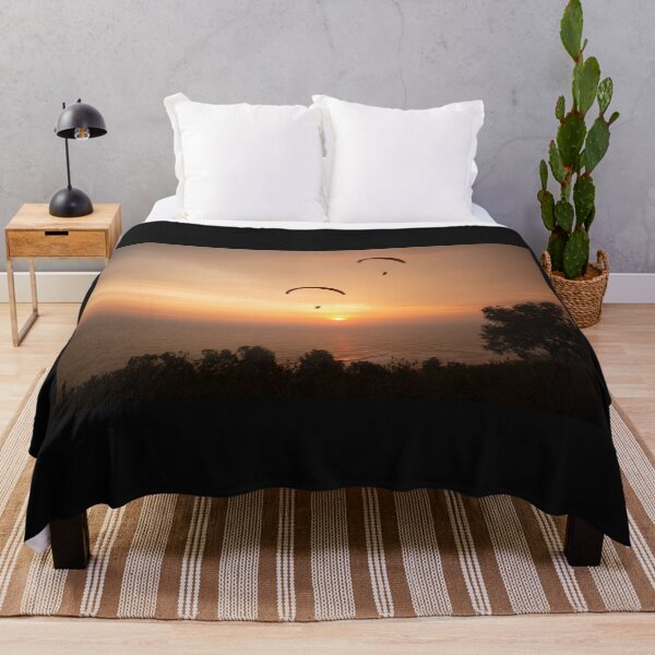 Item preview, Paragliding over the ocean and treetops while golden sunset designed and sold by kall3bu.