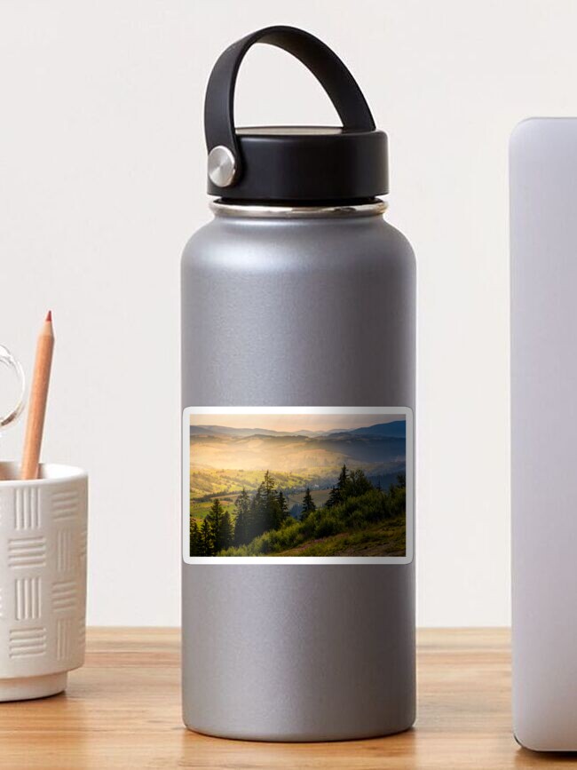 Thumbnail 1 of 3, Sticker, spruce forest on hills at foggy sunrise designed and sold by mike-pellinni.