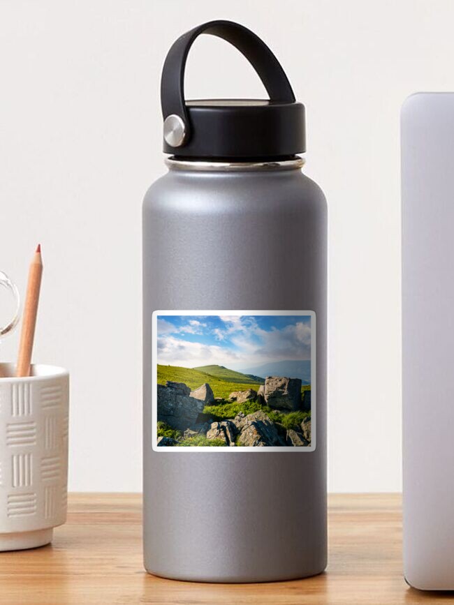 Thumbnail 1 of 3, Sticker, huge boulders on a grassy hillside at sunrise designed and sold by mike-pellinni.