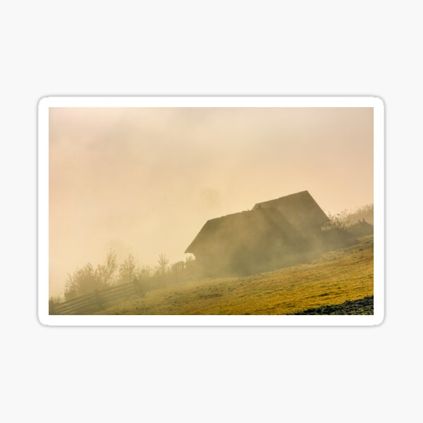 abandoned barn on hillside in fog at sunrise Sticker