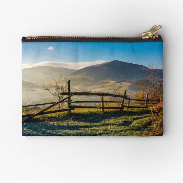 wooden fence near forest in mountains Zipper Pouch