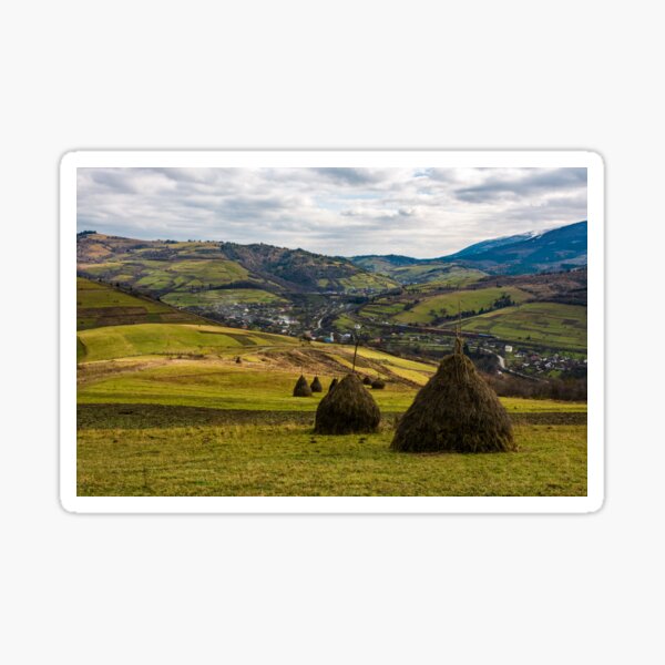 haystacks on grassy meadow in autumn mountains Sticker