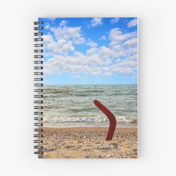 Item preview, Australian Boomerang on sandy beach against of sea surf and sky. designed and sold by IaroslavB.