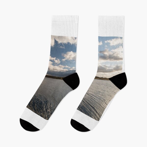 Item preview, lake with small wawes and blue sky with clouds designed and sold by honza28683.
