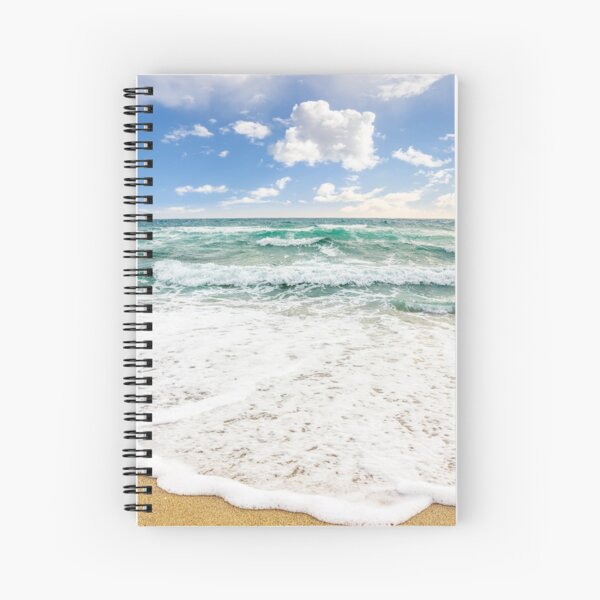 sea waves breaking on the sandy beach Spiral Notebook