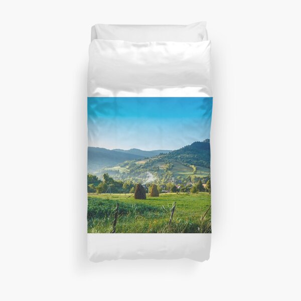 field with haystack on hillside in mountains Duvet Cover