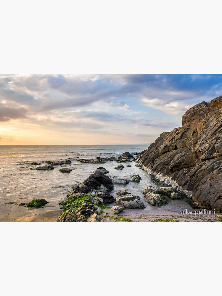 rocks and seaweed on rocky coast of the sea by mike-pellinni