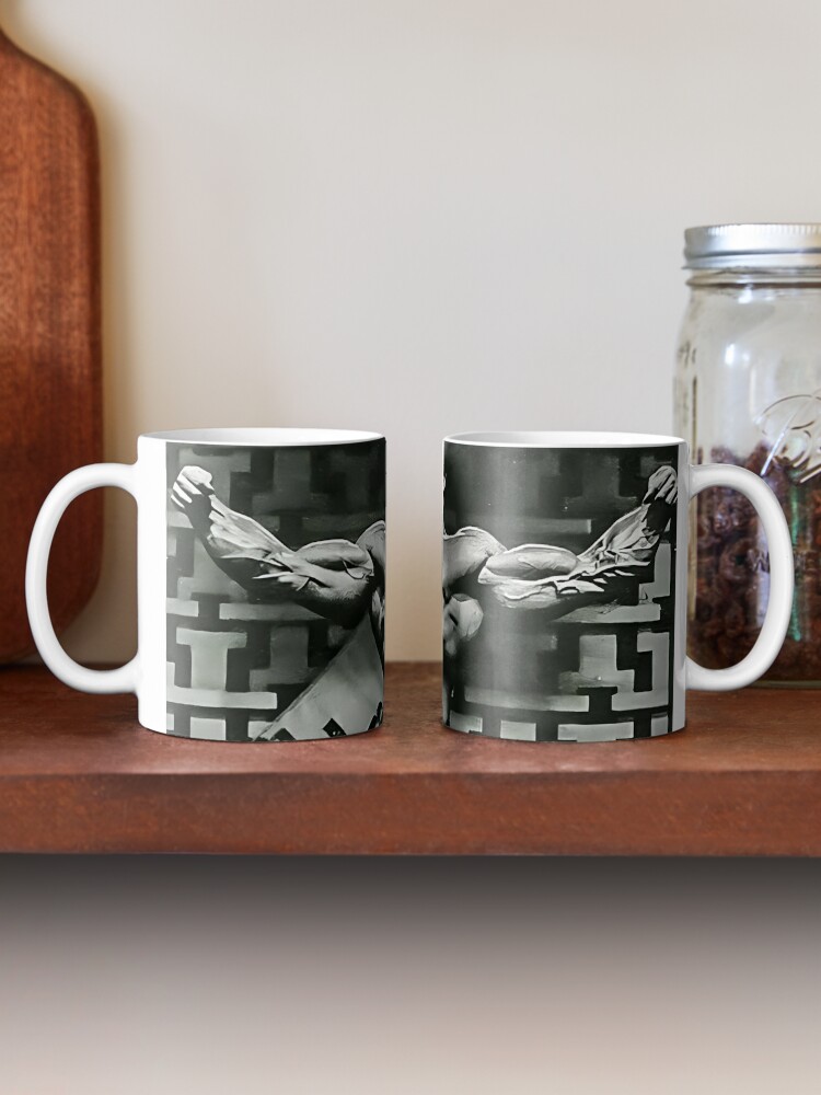 Studio picture of charming young female wearing messy hairstyle and  oversize knitted pullover posing at gray blank wall, holding large mug,  drinking tea, coffee, cocoa or hot chocolate in the morning Stock