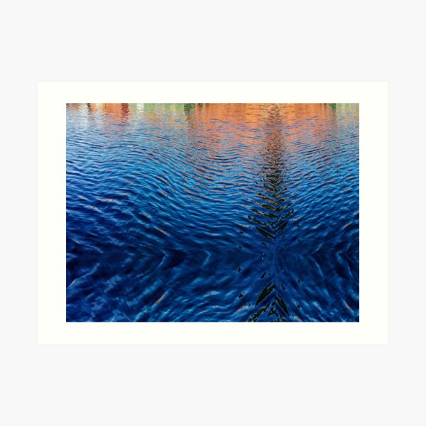 Blue water with orange reflections Art Print