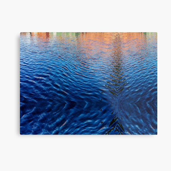 Blue water with orange reflections Metal Print