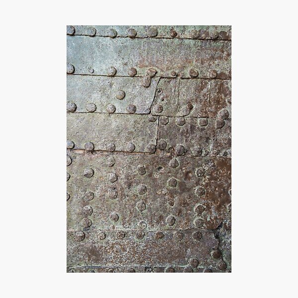 Rusty metal texture. Studded iron plate. Rivets on old rusty metal door. Weathered aged grunge texture. Photographic Print