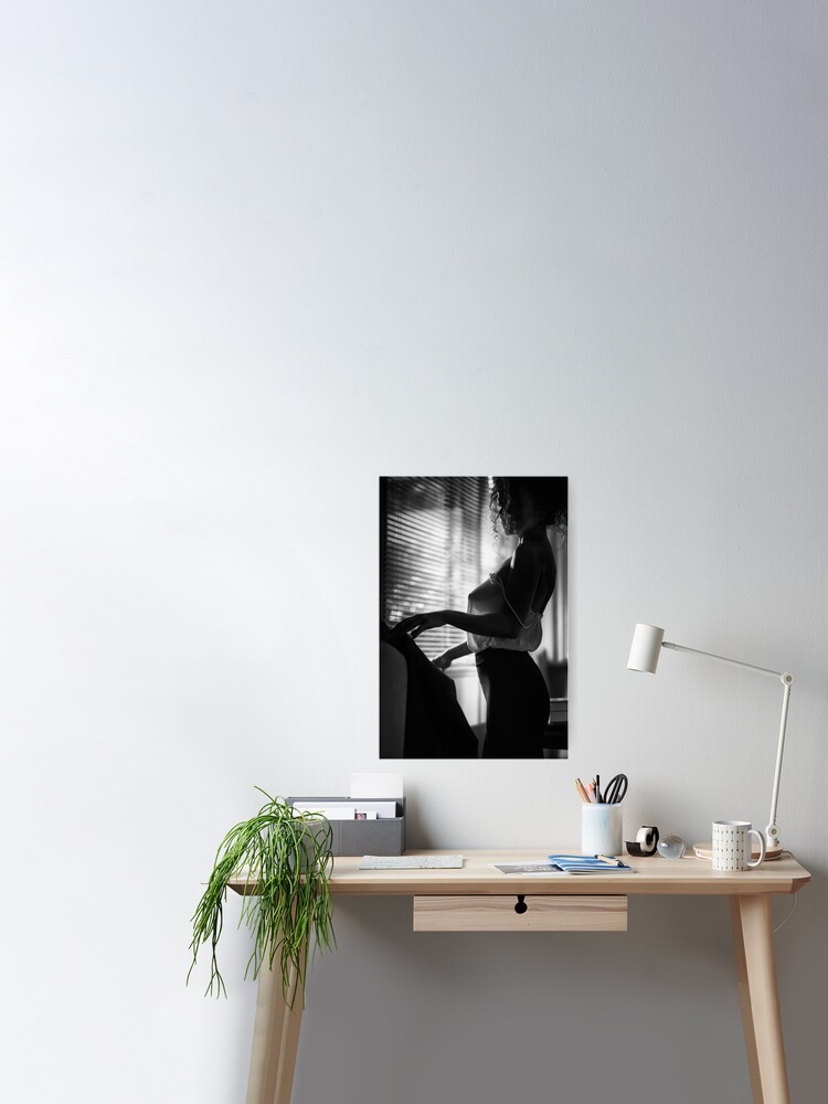 Sensual black and white boudoir portrait of woman in sexy sheer blouse standing by the window art photo print Poster