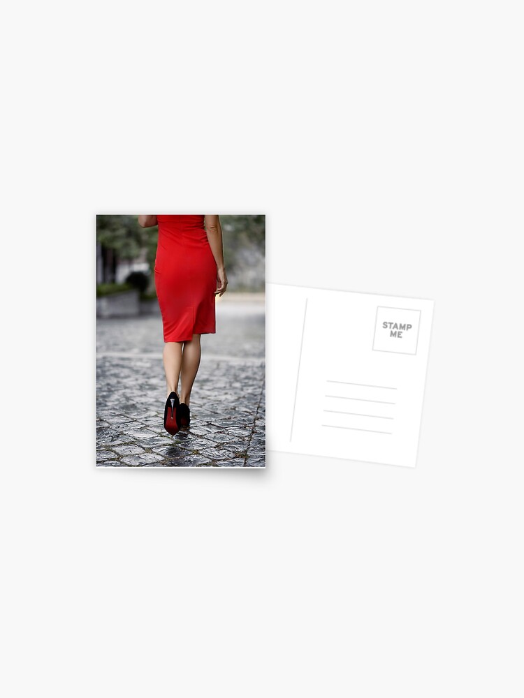 Photo of Closeup of sexy woman legs in high heel shoes and red dress  walking on cobbled city street