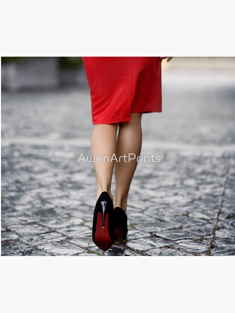 Photo of Closeup of sexy woman legs in high heel shoes and red dress  walking on cobbled city street