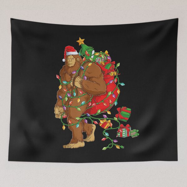 Item preview, Bigfoot Sasquatch Santa Hat Christmas Xmas Tree Pjs Boys Men T-Shirt designed and sold by Knight-Saverin.