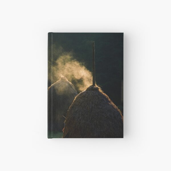 steaming haystack near the forest at sunrise Hardcover Journal