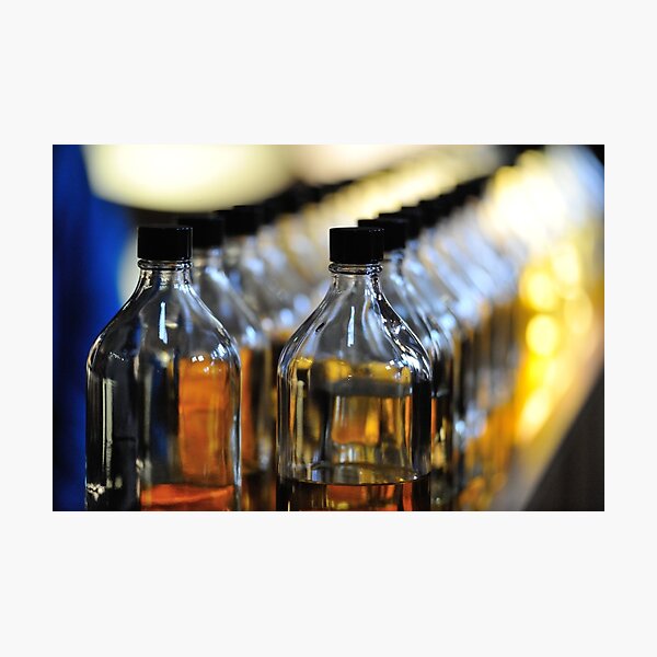 A line of Whisky blenders bottles Photographic Print