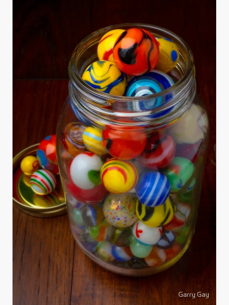 Lovely Classic Glass Marbles Spilling Out Of Jar by Garry Gay