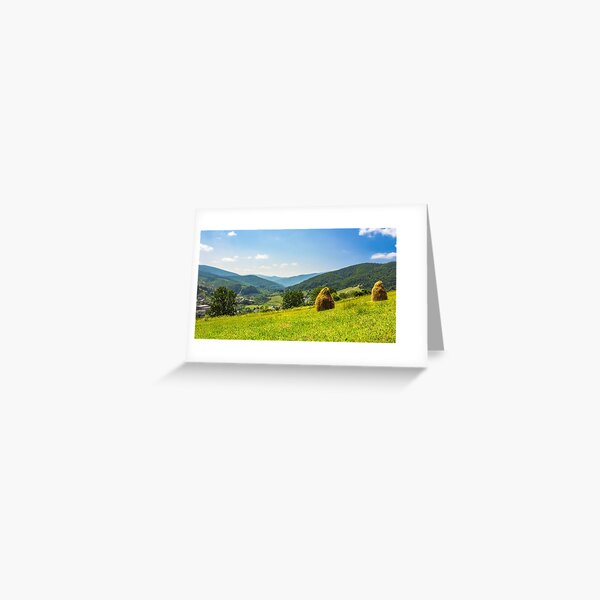 haystacks on hillside near the village Greeting Card