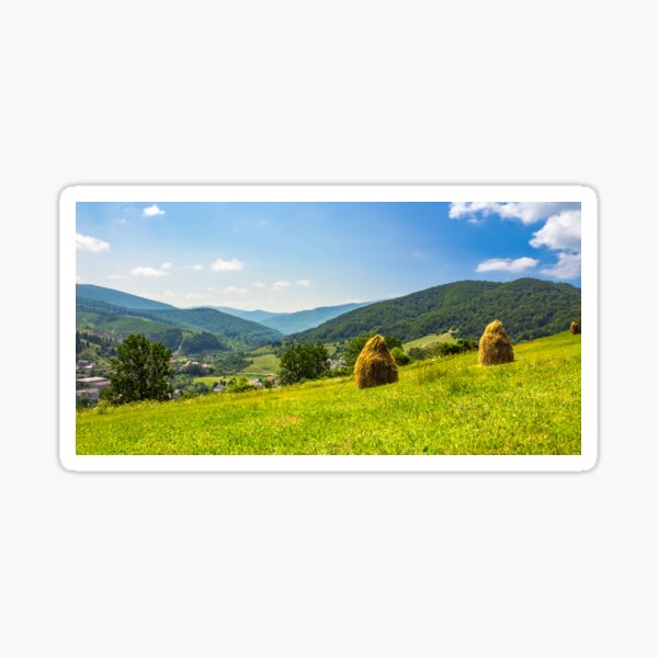 haystacks on hillside near the village Sticker