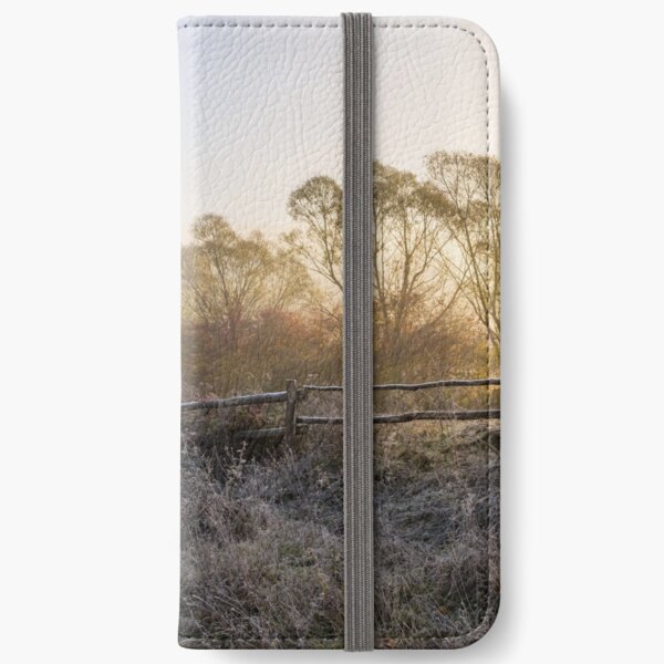 wooden fence in fog on frozen meadow at sunrize iPhone Wallet