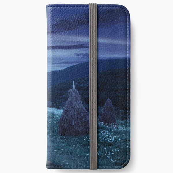 field with haystacks on hillside at night iPhone Wallet
