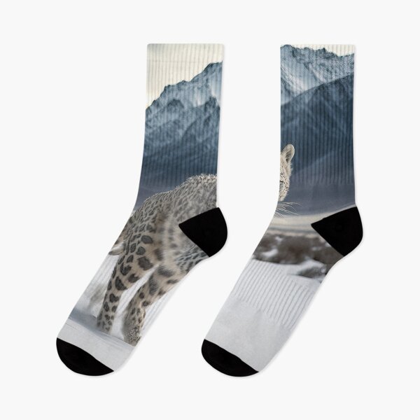 Item preview, Wildlife photography of a snow leopard running in the snow designed and sold by RK - Shop.