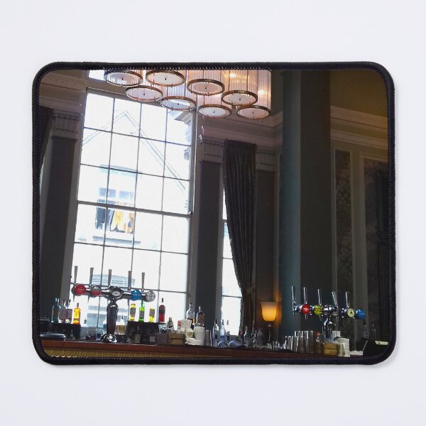 Item preview, Hotel bar interior with high ceiling, ornate hanging lights and tall window behind. designed and sold by claireseyeview.