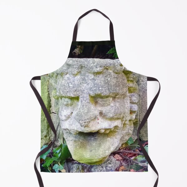 Item preview, Gargoyle stone head with open mouth on a stone wall with green leaves. designed and sold by claireseyeview.