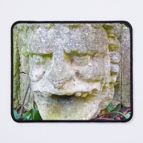 Item preview, Gargoyle stone head with open mouth on a stone wall with green leaves. designed and sold by claireseyeview.