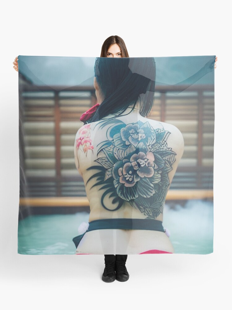 the back of a sitting geisha with yakuza tattoos with