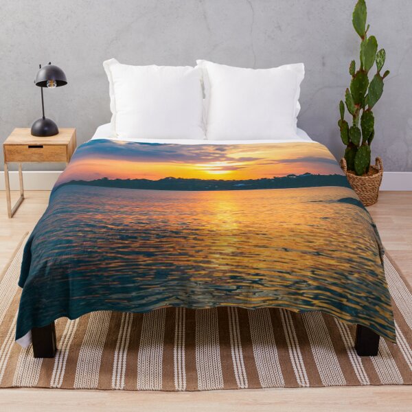 Item preview, Golden sunset over a coastline with orange sunlight on a calm sea. designed and sold by claireseyeview.