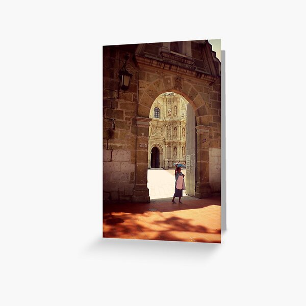 A woman carries bread through a church yard, Oaxaca, Mexico Greeting Card