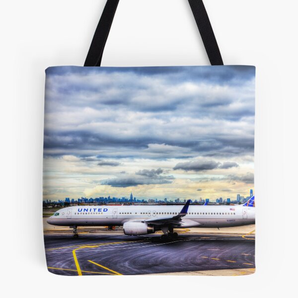 Item preview, United Airlines And Manhattan Skyline JFK Airport designed and sold by Paul Thompson Photography.