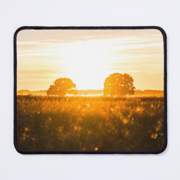 Item preview, Sunset over a field with silhouettes of trees and forest in the background designed and sold by Jens Breuer.