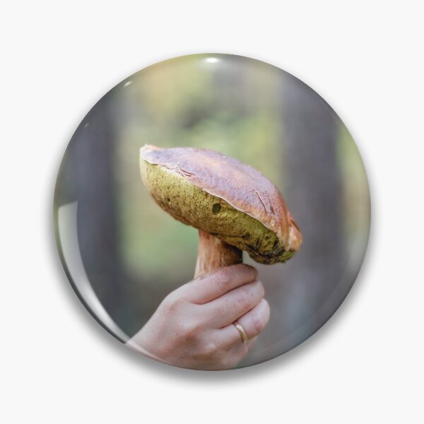 Item preview, A woman's hand holding an edible mushroom in an autumn forest designed and sold by AlbertMi.